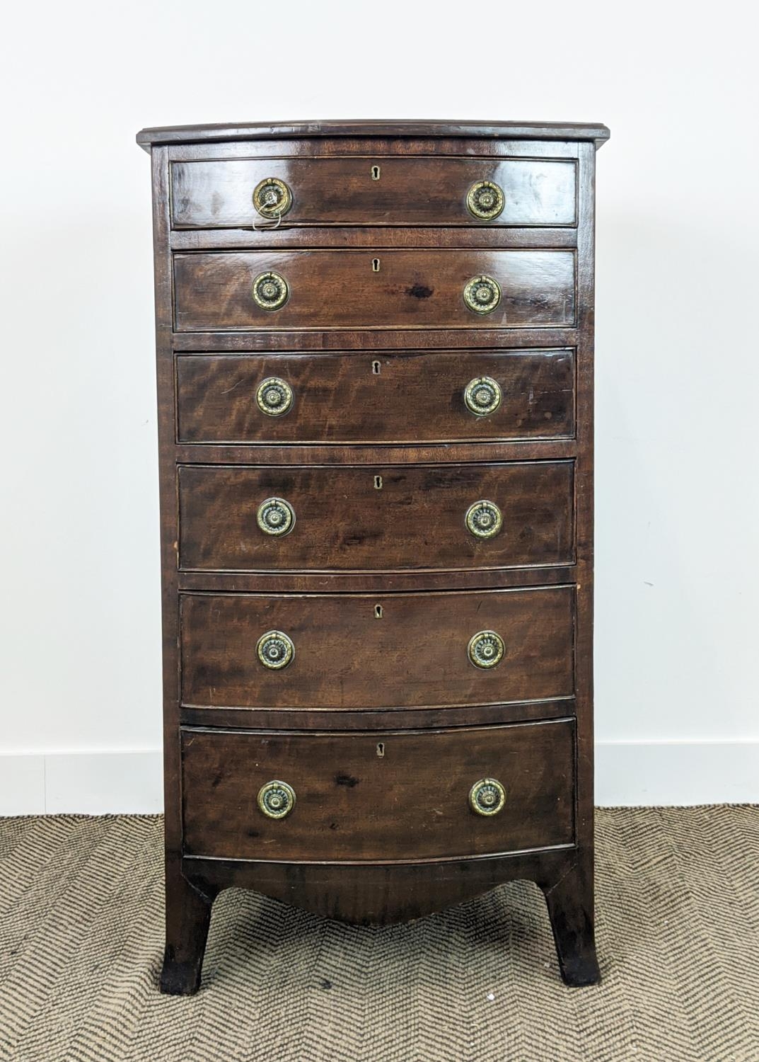 BOWFRONT NARROW CHEST, early 20th century Georgian revival mahogany with six drawers, 115cm H x 61cm