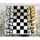 CHESS SET, with gilt and silvered animal pieces, board 60cm x 60cm.