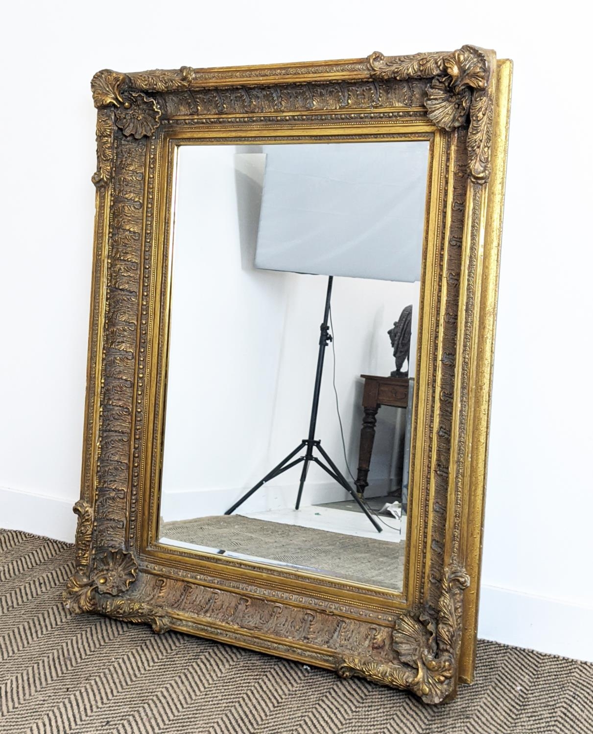 WALL MIRROR, 19th century style gilt framed with shell and leaf decoration, 121cm x 88cm.