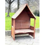 ARBOUR SEAT, traditional form well weathered wood with slatted seat and boarded gable roof, 138cm