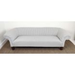 CHESTERFIELD SOFA, Victorian design mahogany in new ticking on turned feet, 63cm H x 217cm x 84cm.