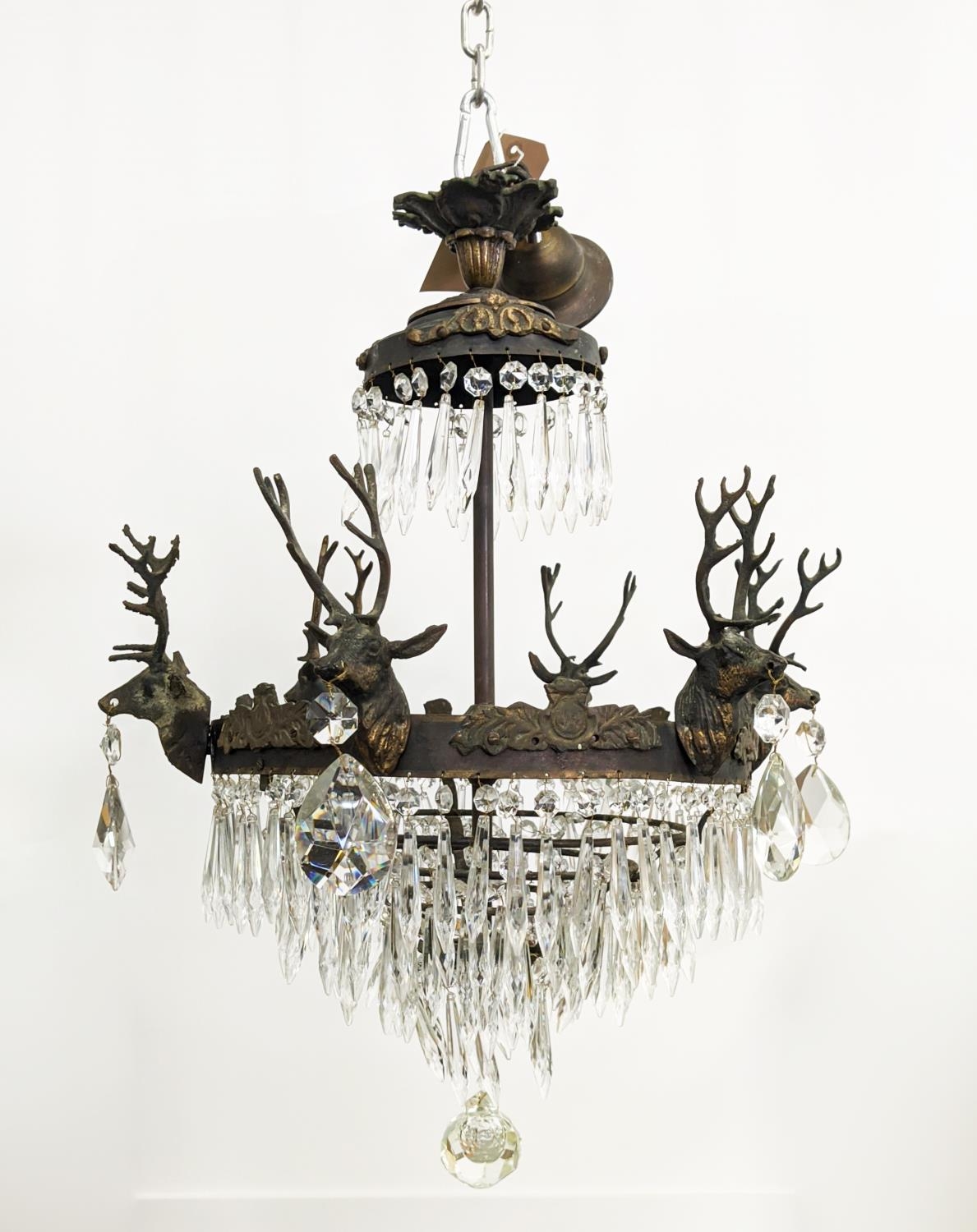CHANDELIER, gilt metal with stag heads, glass drops and six lights, 53cm W x 85cm H overall.