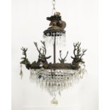 CHANDELIER, gilt metal with stag heads, glass drops and six lights, 53cm W x 85cm H overall.