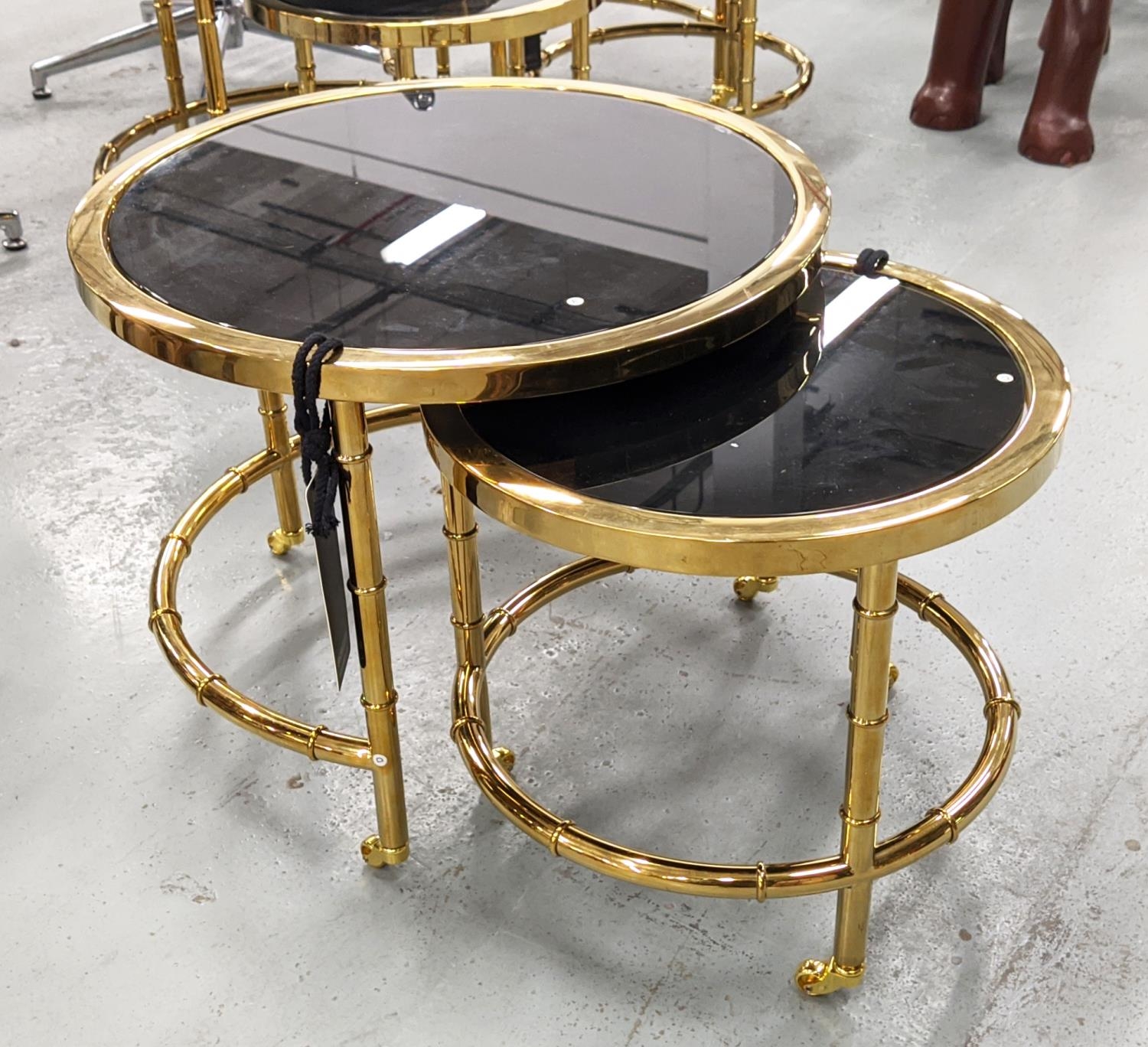 EICHHOLTZ 'NESTOR' SIDE TABLES, a set of two, black glass tops, largest 55cm W x 46cm H. (2)