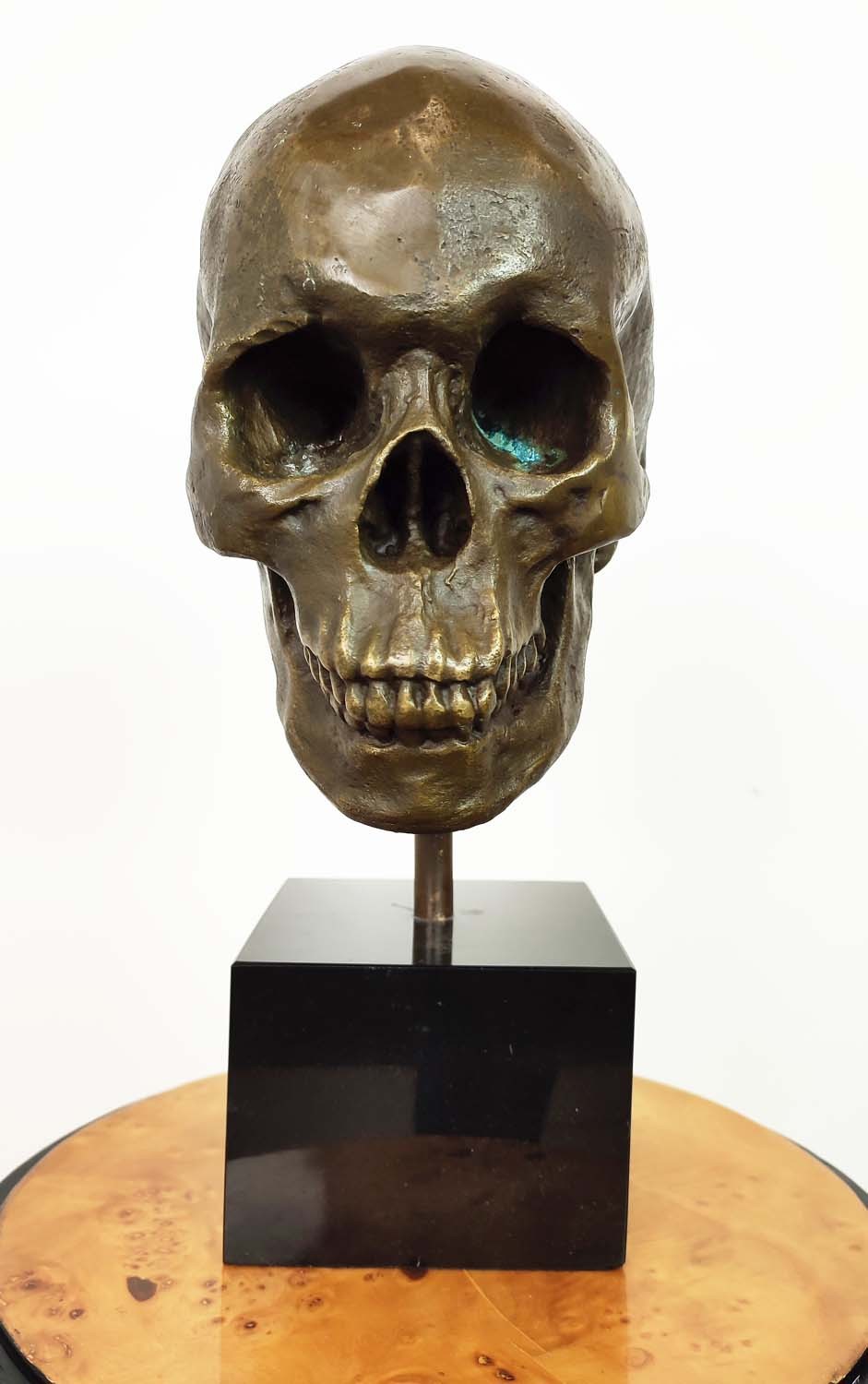 CONTEMPORARY SCHOOL SCULPTURE, bronze, of a skull on a black base, 36cm H. - Image 2 of 5