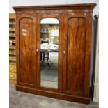 WARDROBE, Victorian mahogany with mirrored door flanked by panel doors enclosing hanging rail and