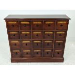 BANK OF DRAWERS, with sixteen drawers and vintage apothecary style labels, 89cm H x 104cm W x 27cm