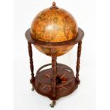 GLOBE COCKTAIL CABINET, in the form of an antique terrestrial globe on stand with rising lid and