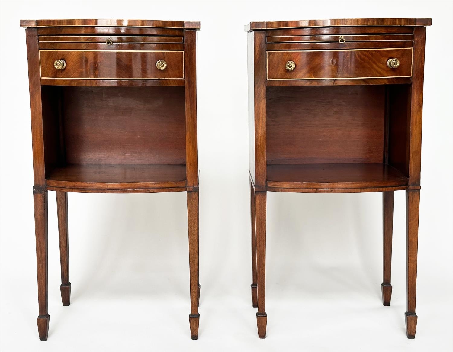 BOWFRONT LAMP TABLES, a pair, George III design figured mahogany and boxwood lined each with