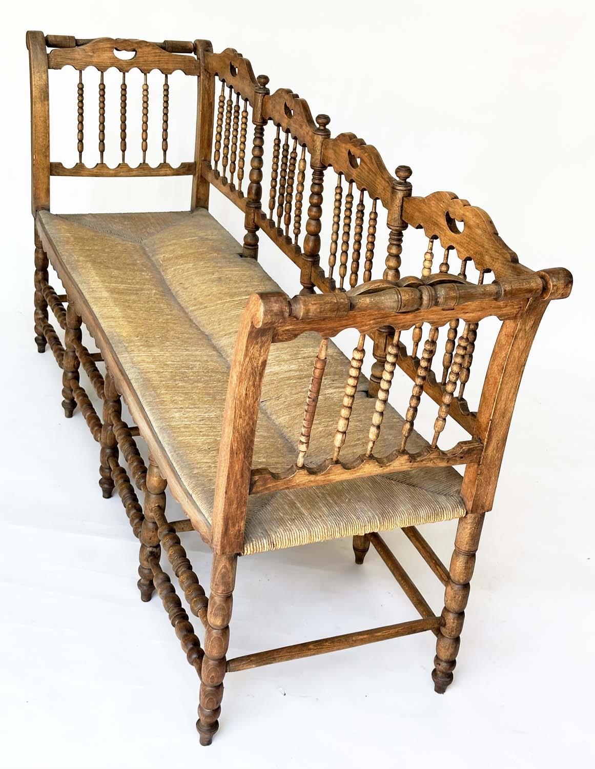 HALL SEAT, 19th century English, William Morris style fruitwood with bobbin turned frame and rush - Image 11 of 11