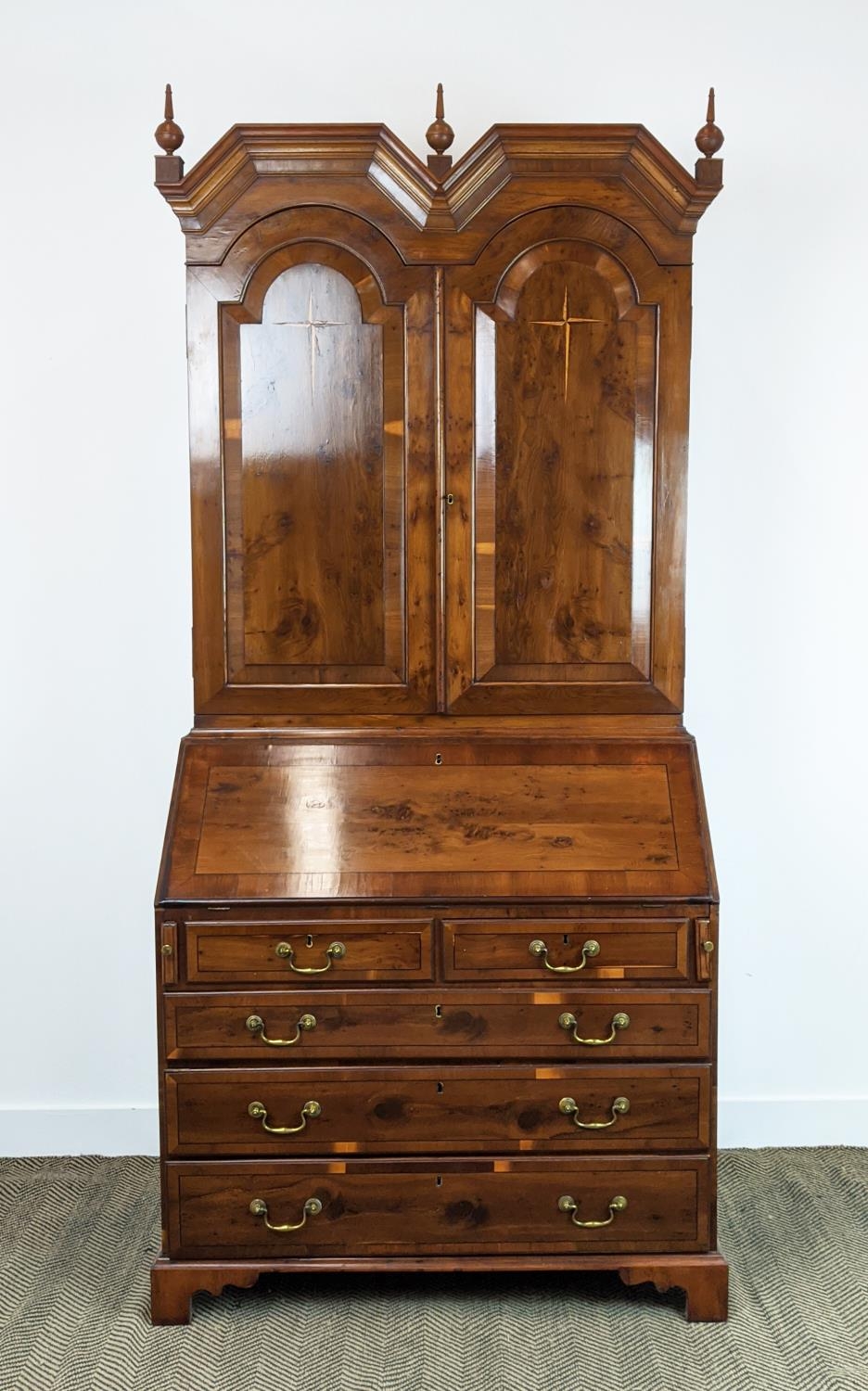 BUREAU CABINET, George II style yewwood and stellar inlaid with three finials over panelled doors
