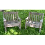 GARDEN ARMCHAIRS BY BRIDGMAN & CO LTD, a pair, well weathered teak with generous seats, slatted