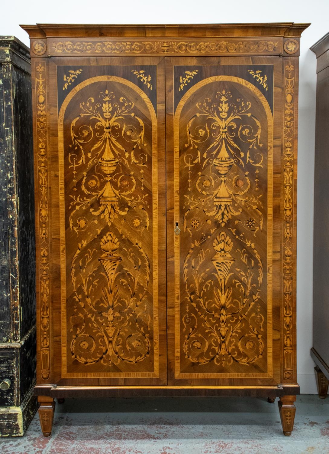 WARDROBE, Italian walnut and marquetry of two doors enclosing a hanging rail and shelves, 211cm H