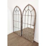 GARDEN MIRRORS, a pair, with arched metal frames, 159cm H x 66cm W. (2)