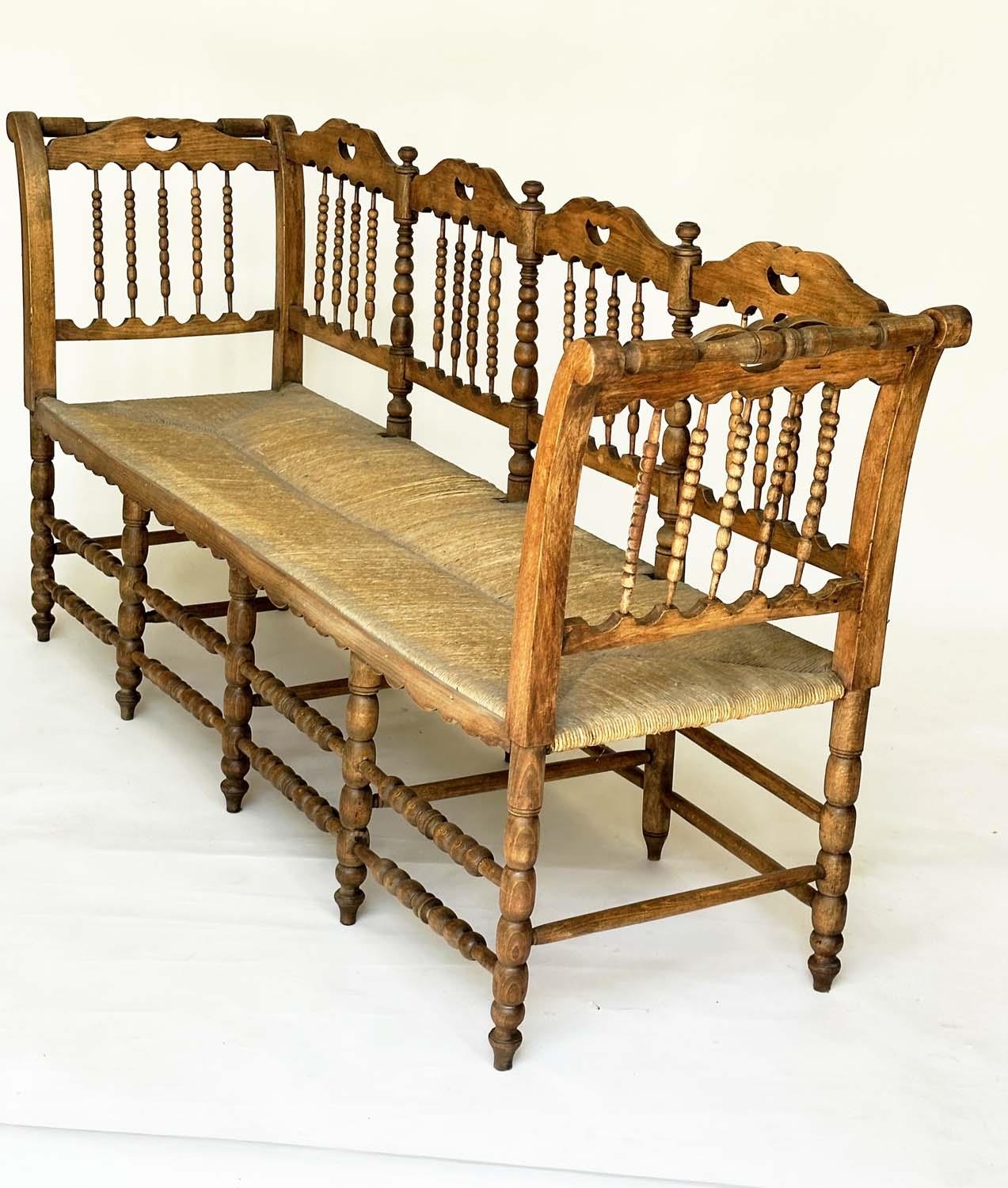 HALL SEAT, 19th century English, William Morris style fruitwood with bobbin turned frame and rush - Image 9 of 11