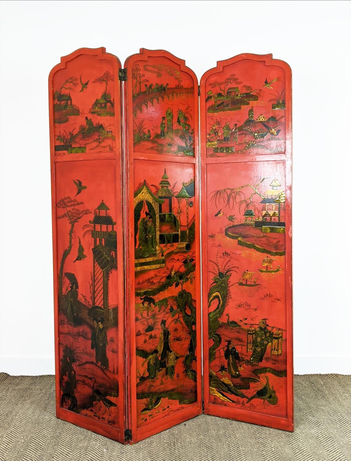 CHINOISERIE SCREEN, early 20th century red lacquer, three fold, each panel 178cm x 46cm W, with gilt