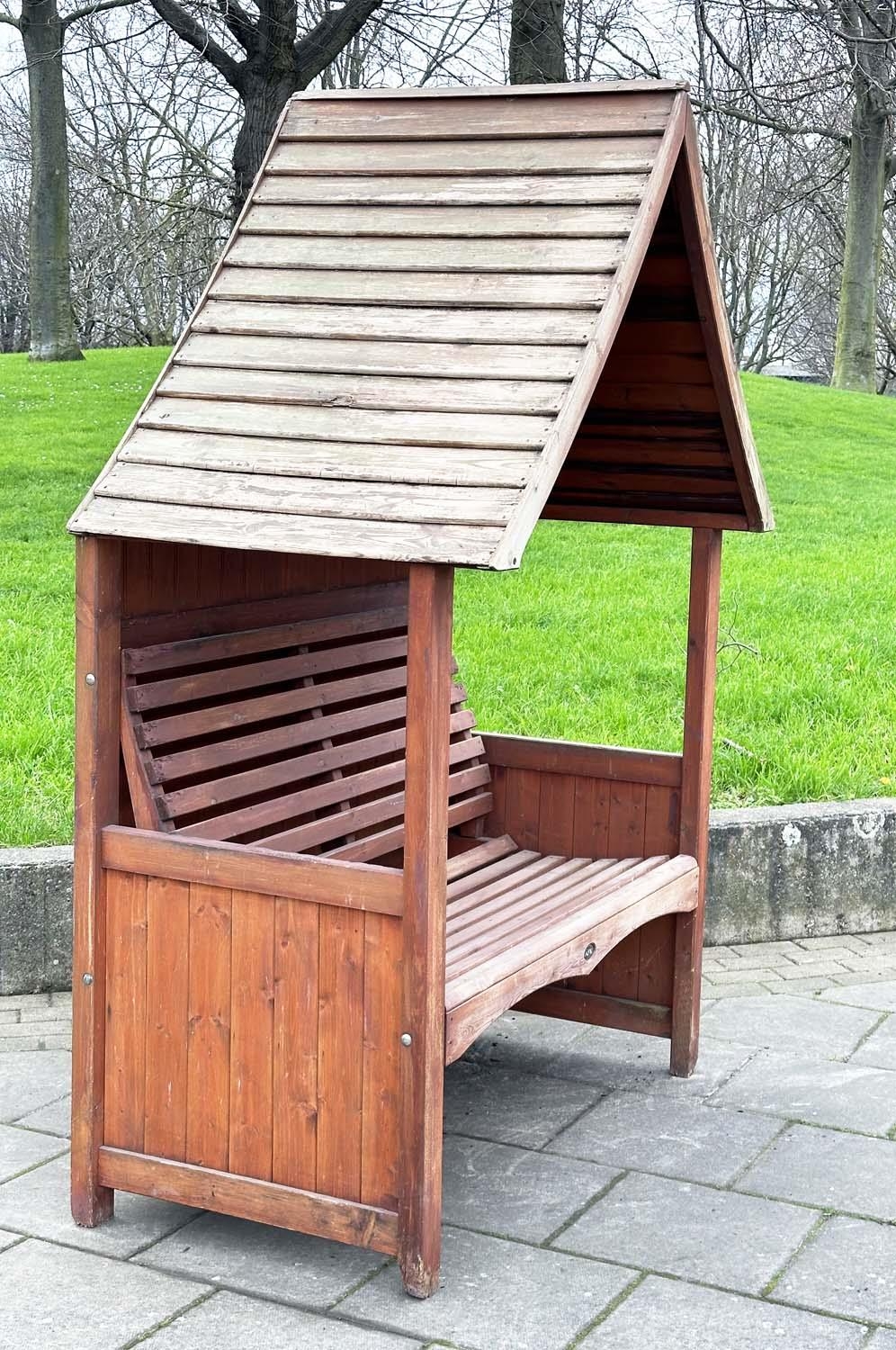 ARBOUR SEAT, traditional form well weathered wood with slatted seat and boarded gable roof, 138cm - Image 5 of 5