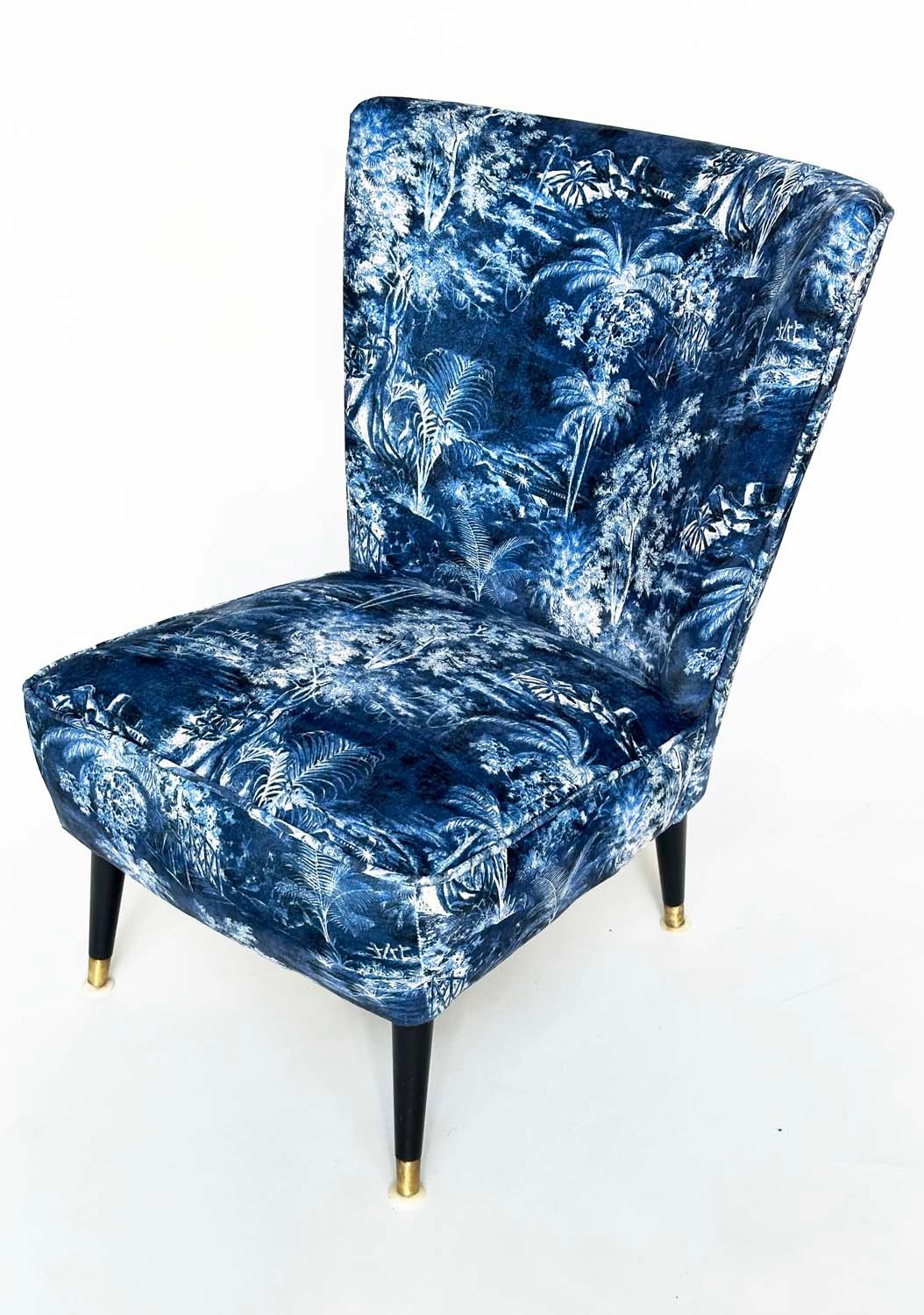 COCKTAIL CHAIR, 1950s with Linwood fabric upholstery and brass capped ebonised supports, 56cm W.