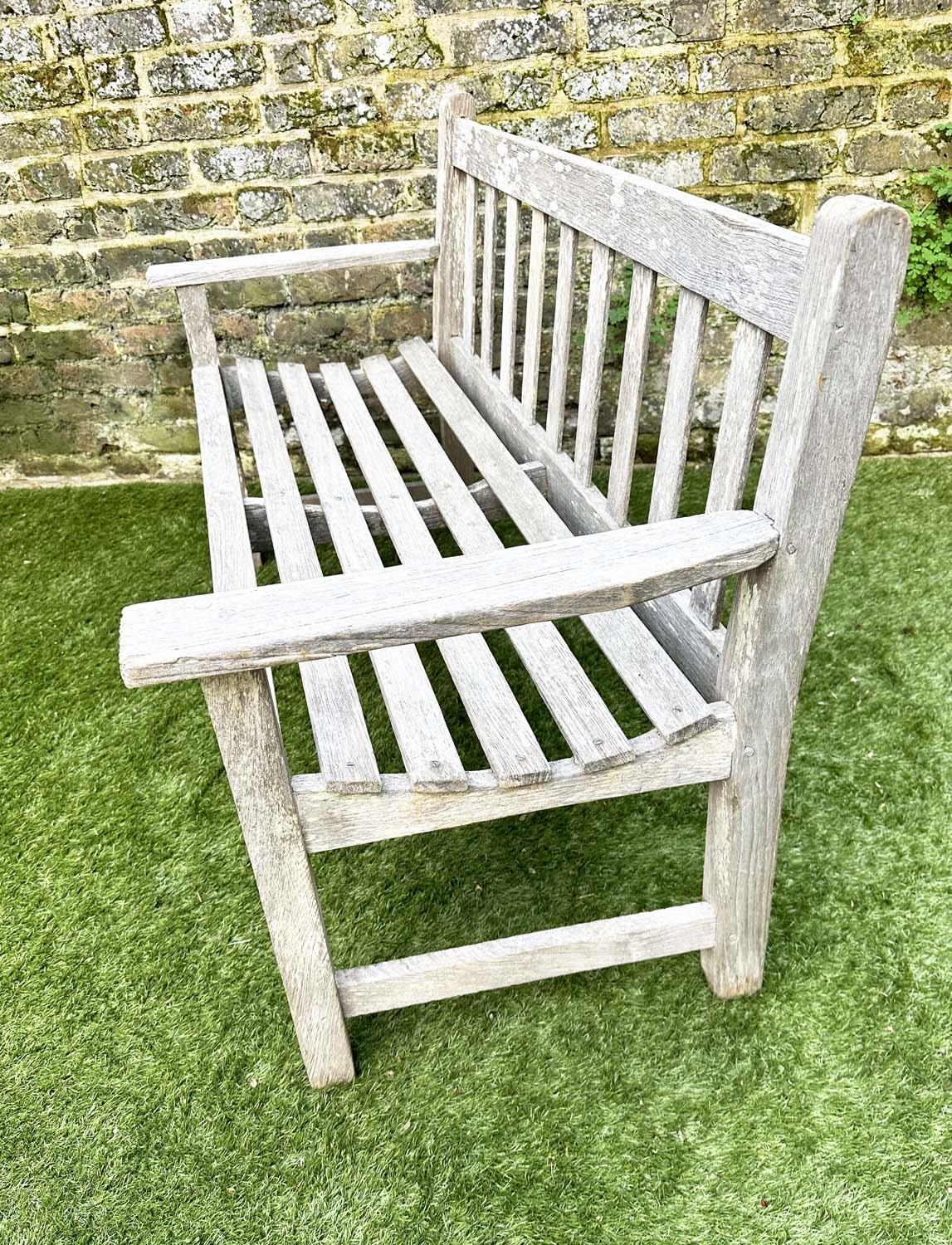 GARDEN BENCH, silvery weathered teak of slatted construction, 130cm W, by 'Lister'. - Image 6 of 8