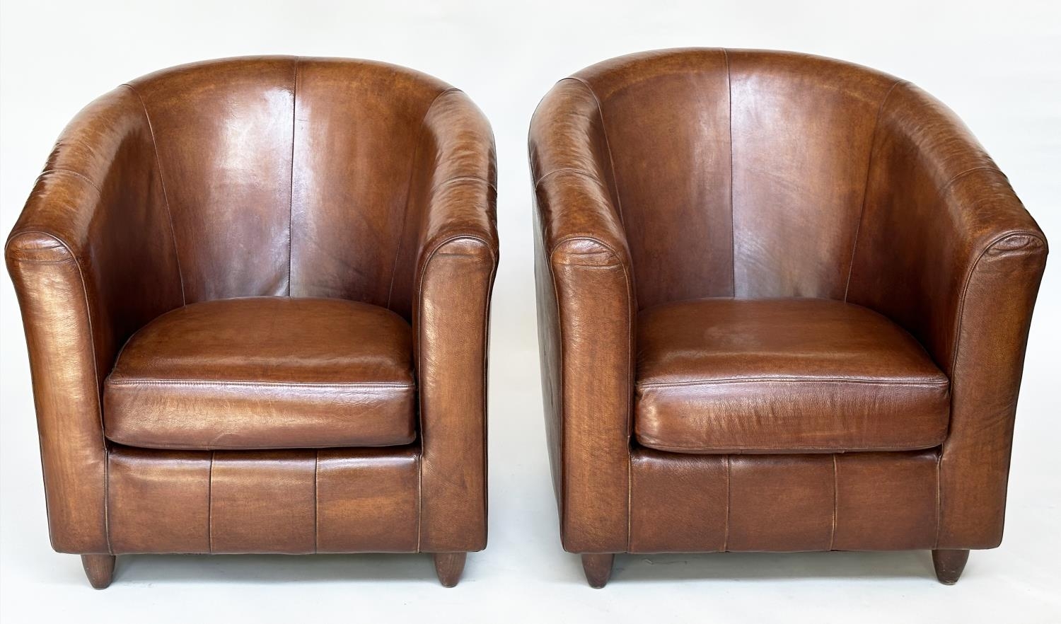 TUB ARMCHAIRS, a pair, natural soft mid brown leather upholstered with rounded backs, 78cm W. (2)