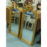 WALL MIRRORS, a pair, ornate gilt frames, 114cm H x 50cm. (2)