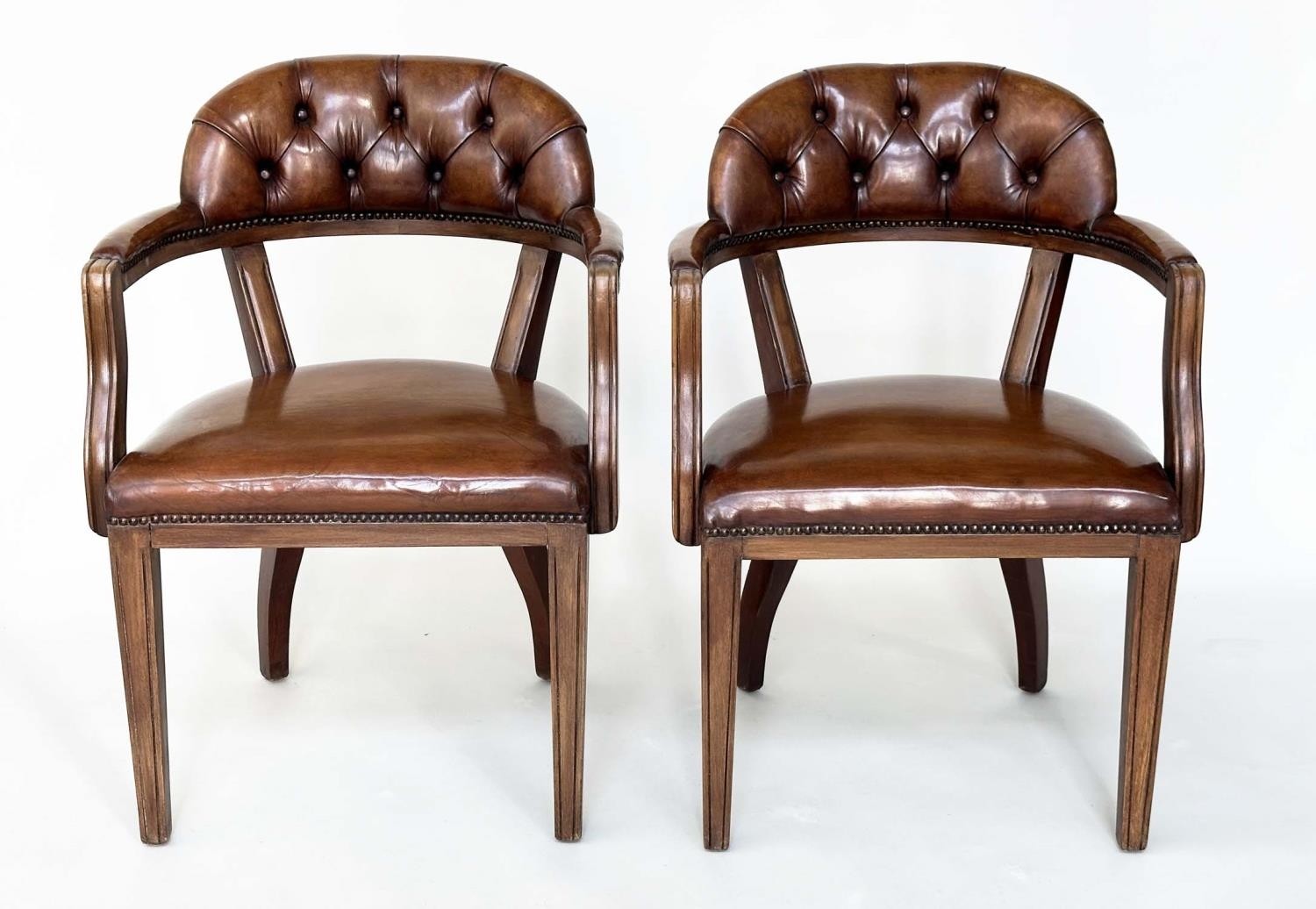 LIBRARY ARMCHAIRS, a pair, Georgian design antique studded and buttoned soft tan brown leather
