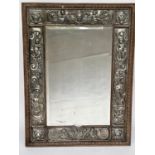 WALL MIRROR, late 19th century Continental oak rectangular bevelled mirror within repoussé