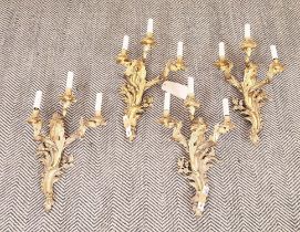 WALL LIGHTS, four, Rococo style gilt metal each with three branches, 65cm H. (4)