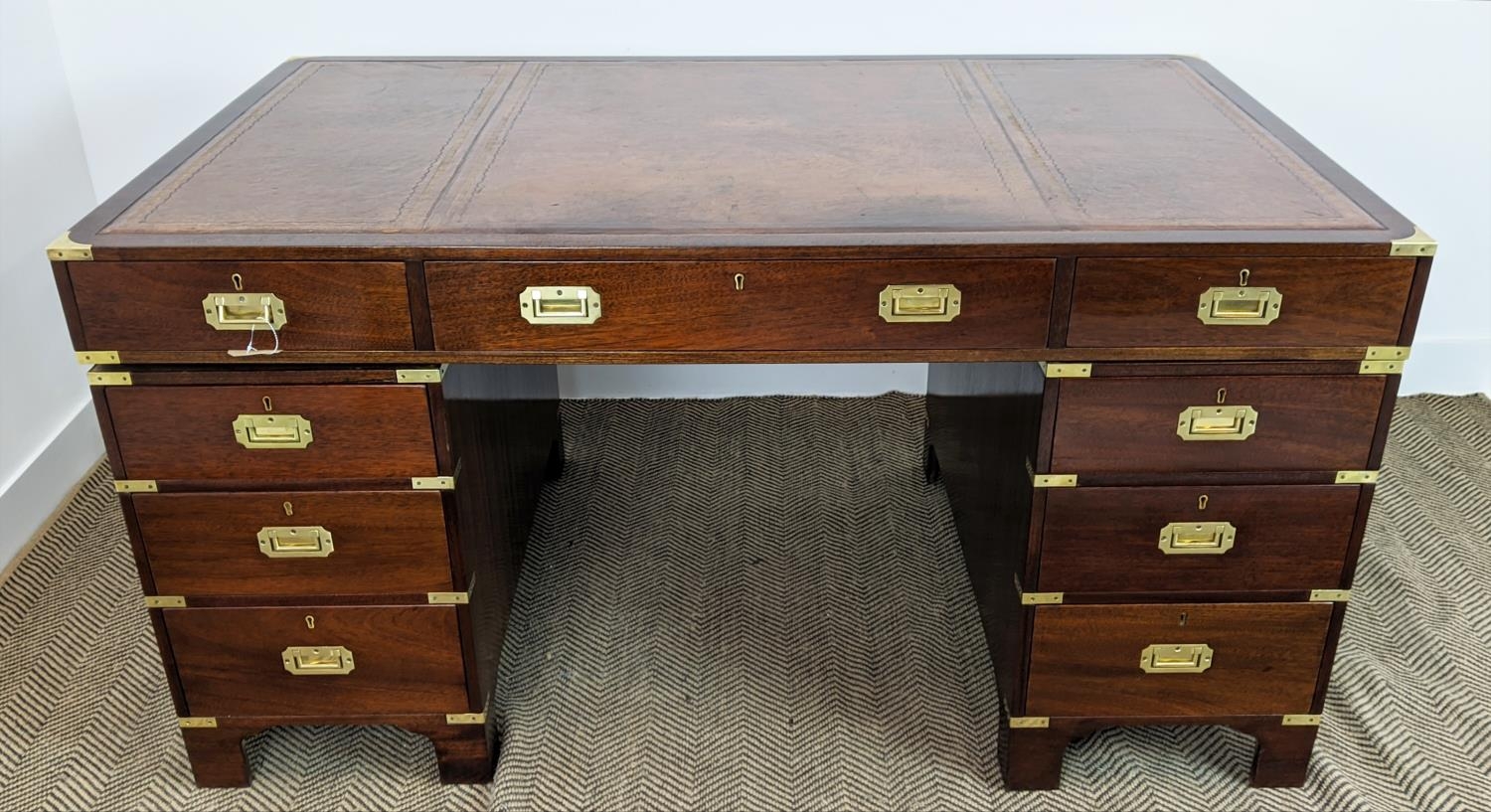 CAMPAIGN STYLE PEDESTAL DESK, mahogany and brass bound with brown leather top above nine drawers,