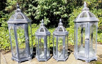 LANTERNS, two graduated pairs, metal and glass, larger 63cm H x 26cm. (4)