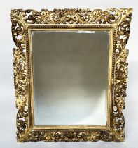 FLORENTINE WALL MIRROR, late 19th/early 20th century Italian carved giltwood with bevelled plate and
