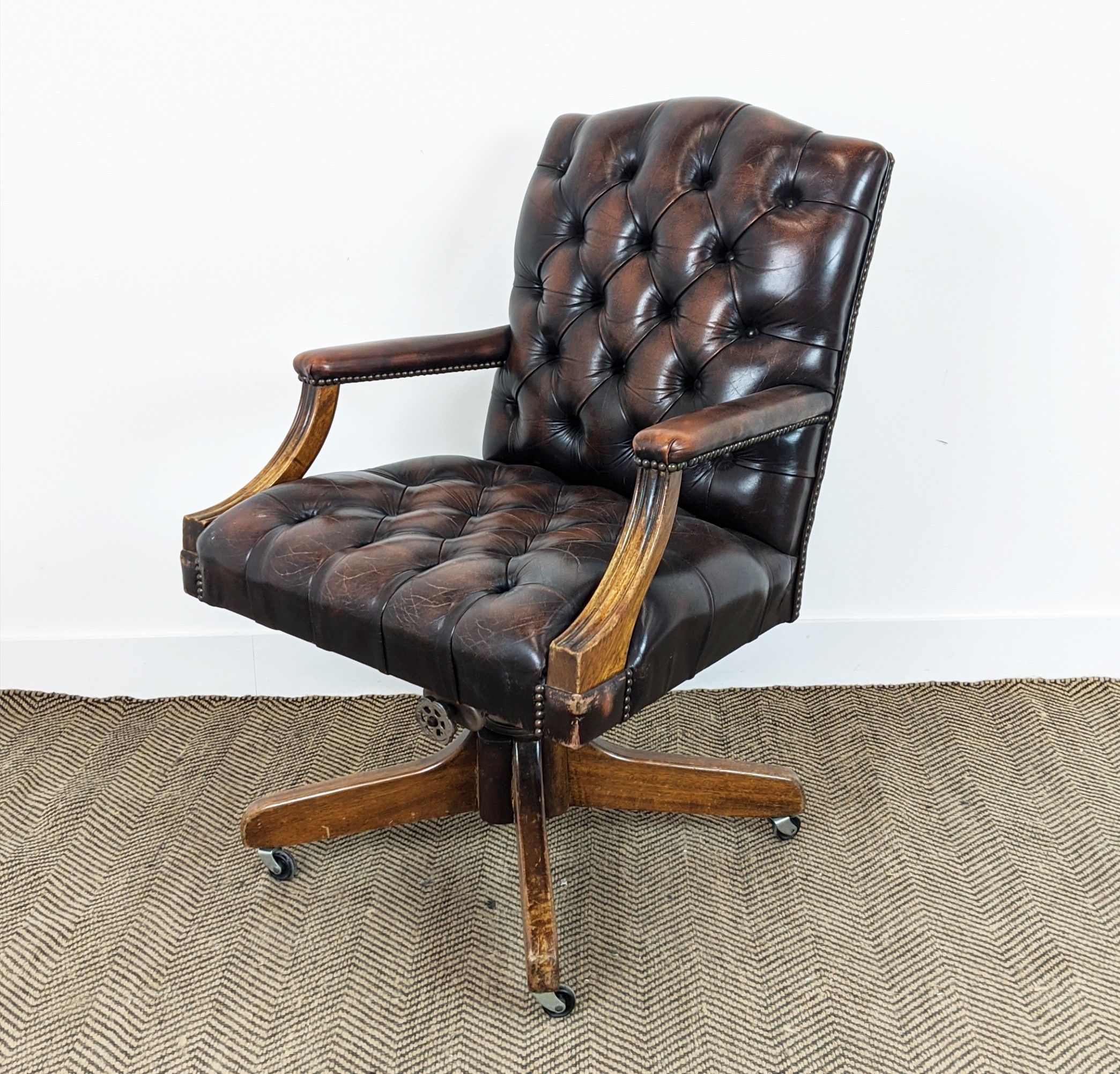 CAPTAINS DESK CHAIR, 'Hillcrest', buttoned brown leather on swivel base, mahogany frame, 96cm H x