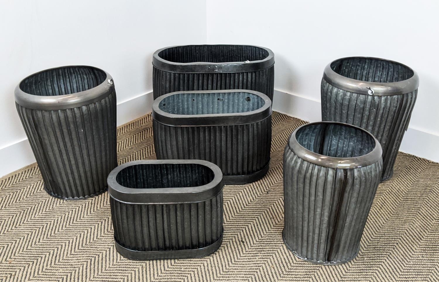 PLANTERS, two graduated sets of three, metal, 57cm x 34cm x 36cm at largest. (6)