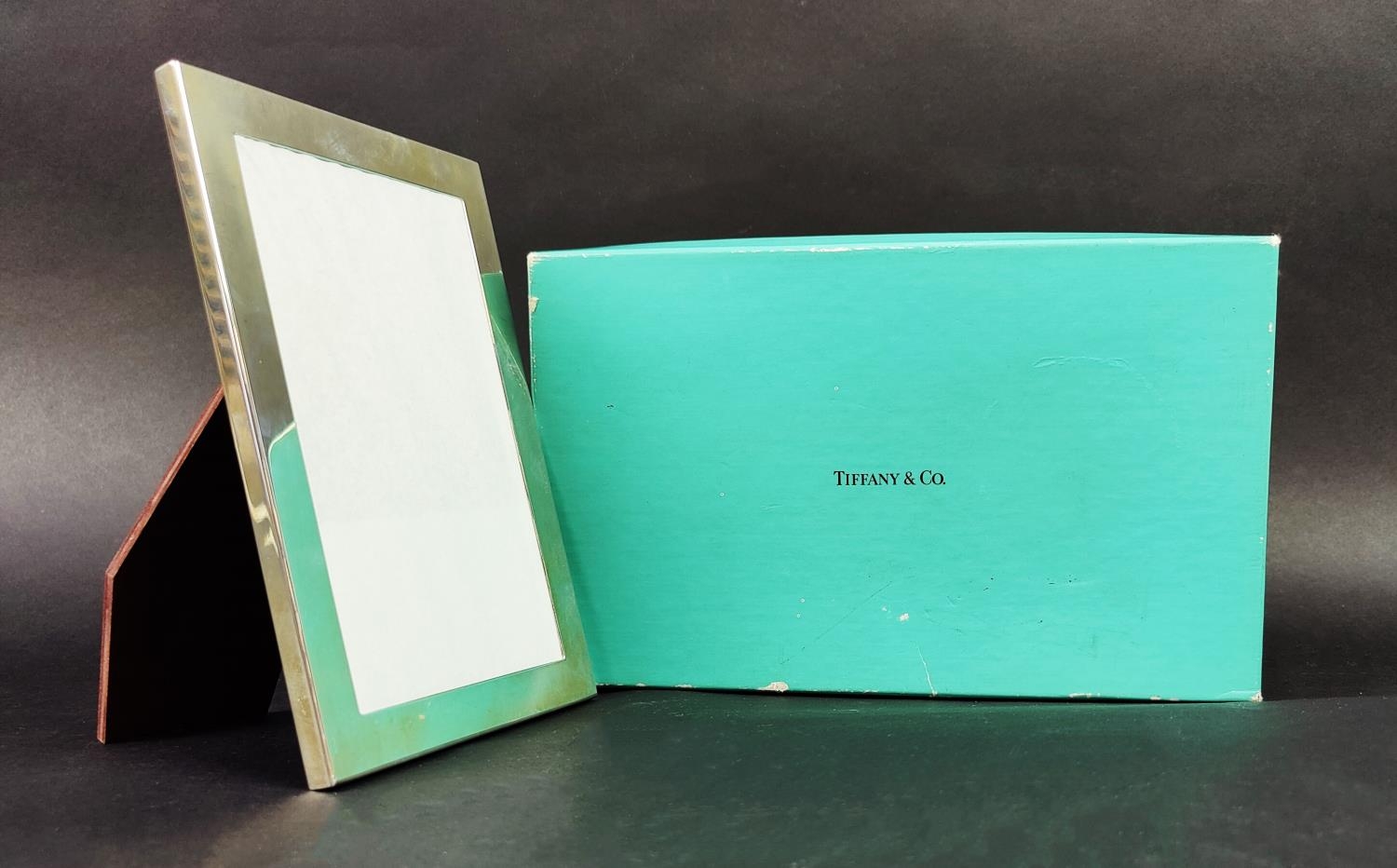 A TIFFANY & CO. STERLING SILVER PHOTOFRAME, 18cm high, 13cm wide, complete with original box and - Image 10 of 12