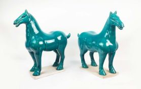 TANG STYLE POTTERY HORSES, a pair, with a turquoise glaze, 50cm L x 51cm H. (2)