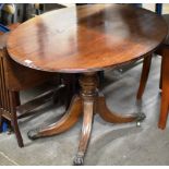 MAHOGANY SNAP TOP TABLE ON PAW FEET WITH BRASS CASTORS