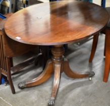 MAHOGANY SNAP TOP TABLE ON PAW FEET WITH BRASS CASTORS