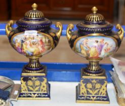 A PAIR OF VIENNA STYLE PORCELAIN LIDDED URNS