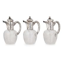 A set of three French early 20th-century silver-mounted claret jugs