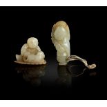 TWO PALE CELADON JADE WITH RUSSET SKIN CARVINGS OF BOY AT PLAY