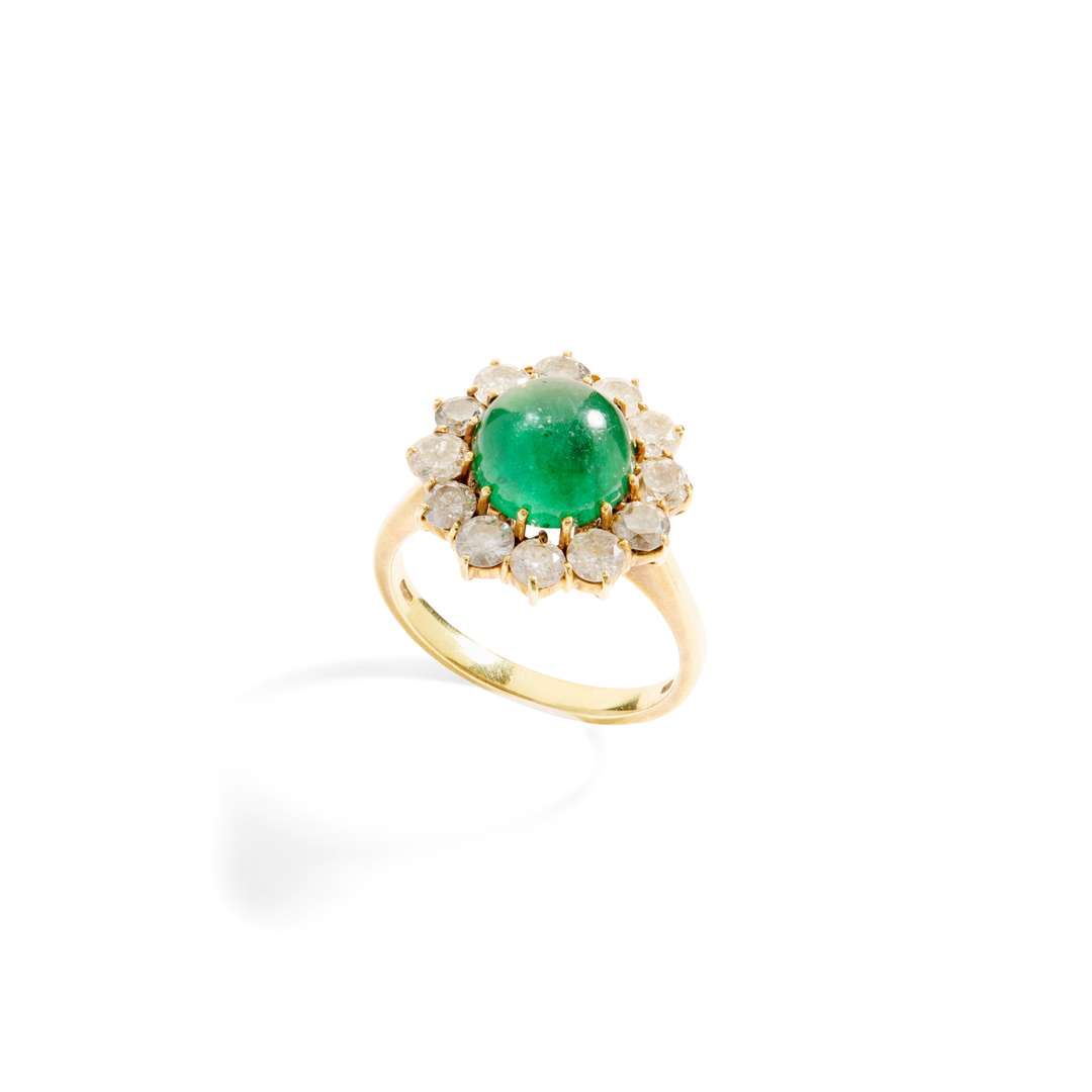 An emerald and diamond cluster ring