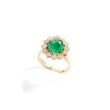 An emerald and diamond cluster ring