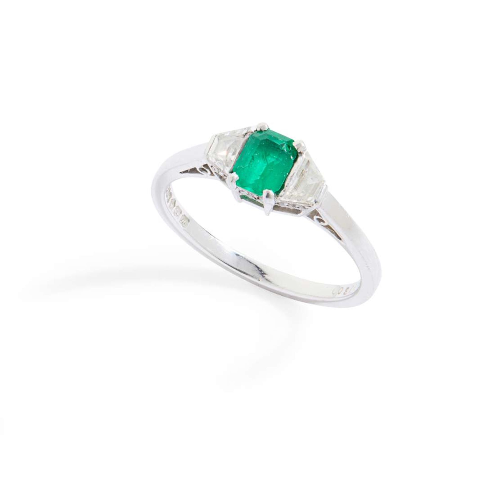 A platinum emerald and diamond three-stone ring