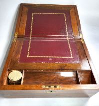 A mahogany writing slope with leather inlay, with a glass inkwell, a removable tray for pens, a