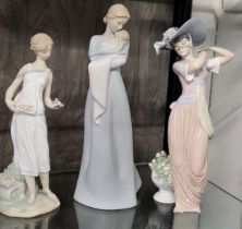 Lladro Mother with baby standing figure, 31cm, and two ladies, 27cm to 30cm. (3)