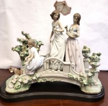 Lladro figure group of two young ladies and girl with puppy on bridge, 49cm wide, 48cm high, with