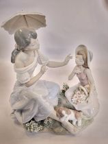 Lladro young lady with young girl and puppy, 28cm, and white card box for parasol.