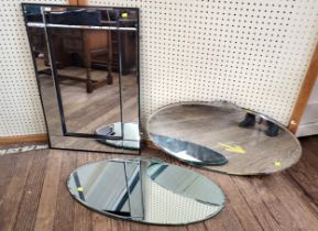 Three wall mirrors comprising of a pair of 1940's oval bevelled mirrors (46cm x 89cm) and a modern