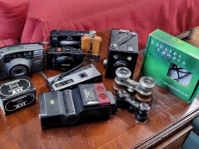 A large collection of vintage cameras, together with binoculars and hip flask.