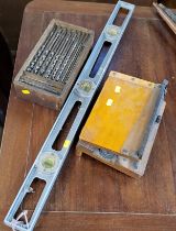 A vintage spirit level, auger and paper guillotine
